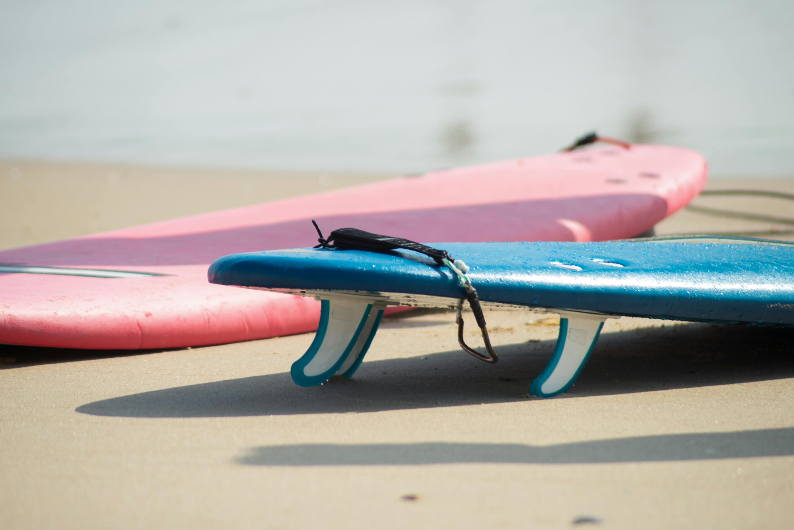 Home Close-up of colorful surfboards on a sandy beach in Portugal. Perfect for surfing enthusiasts.